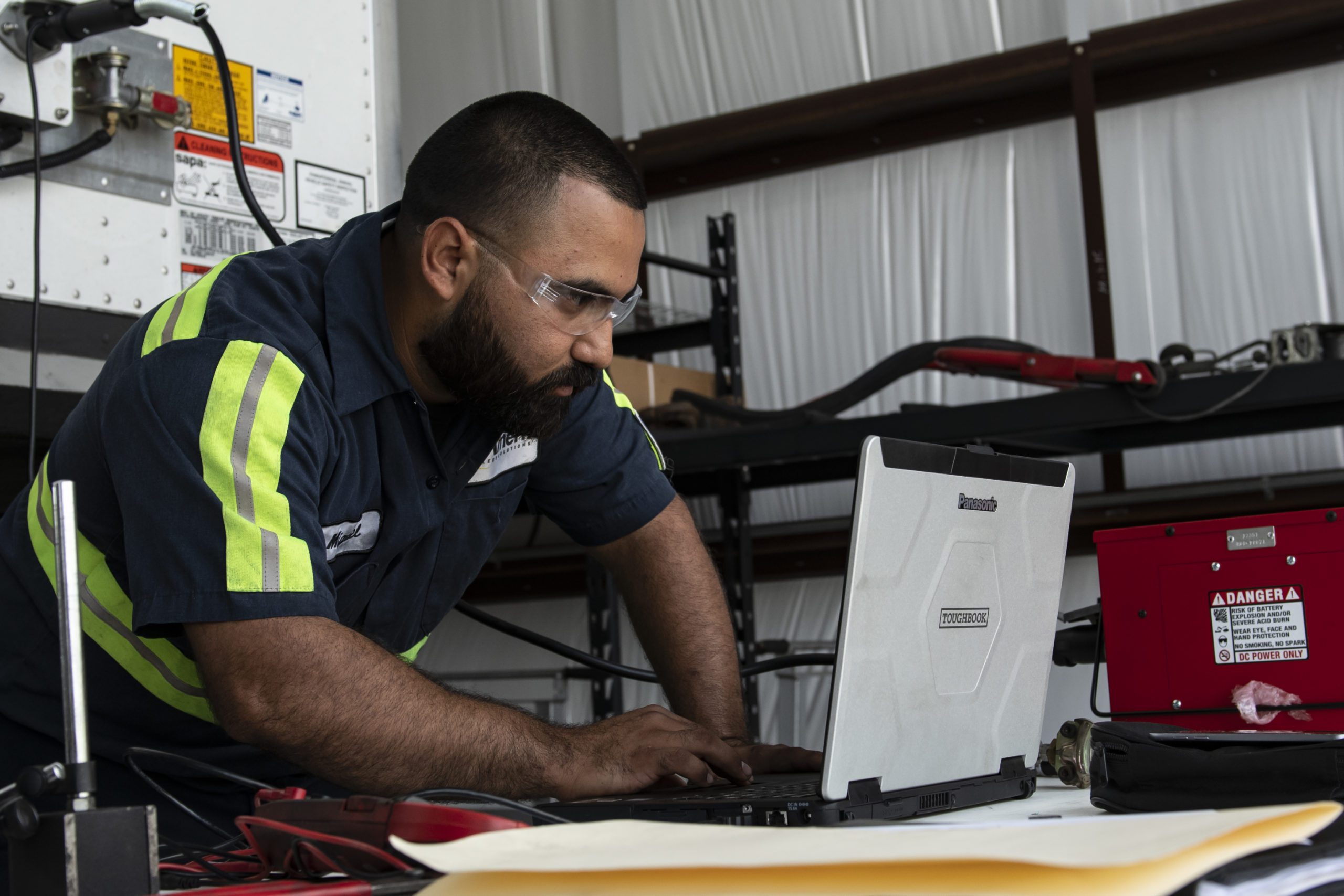 An Amerit Mobile Fleet Technician Updates the Client Portal Via Laptop.