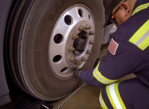 technician working with tires and chains to prepare your fleet for winter months