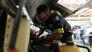 technician repairing engine to reduce vehicle downtime