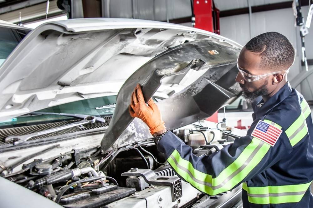 Amerit technician performing on site fleet maintenance while following best safety practices.