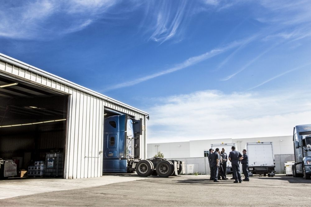 Five Amerit technicians outside of a Fleet Service Center.
