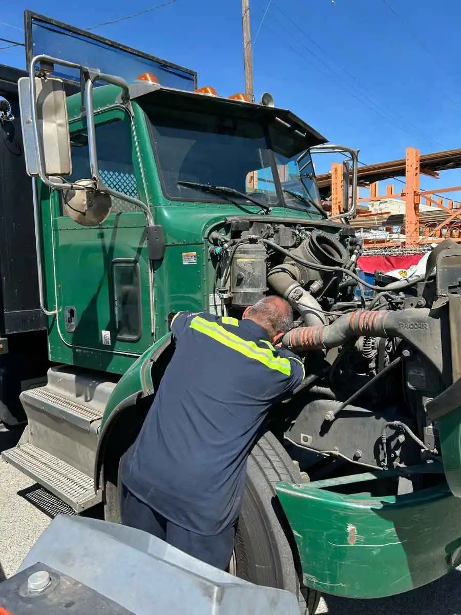 amerit technician working on tractor trailer engine