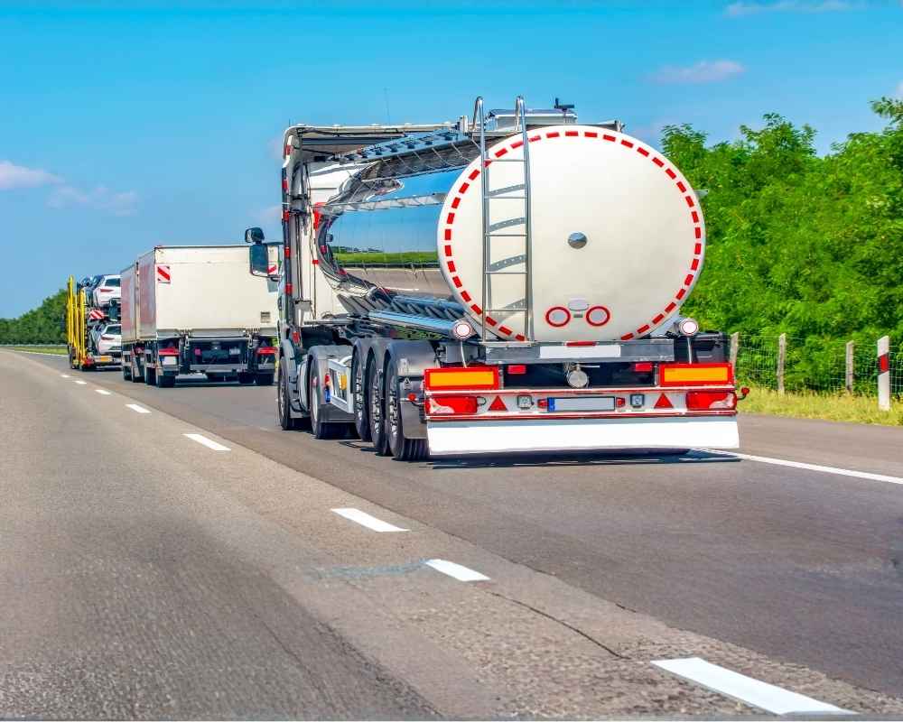 Tank truck driving down highway.