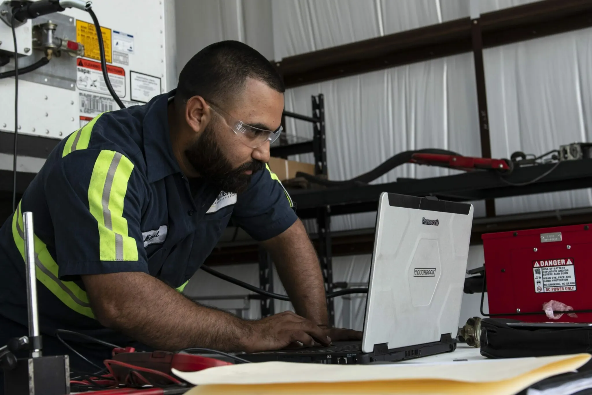 Technician reviews the utility fleet management software on his computer.