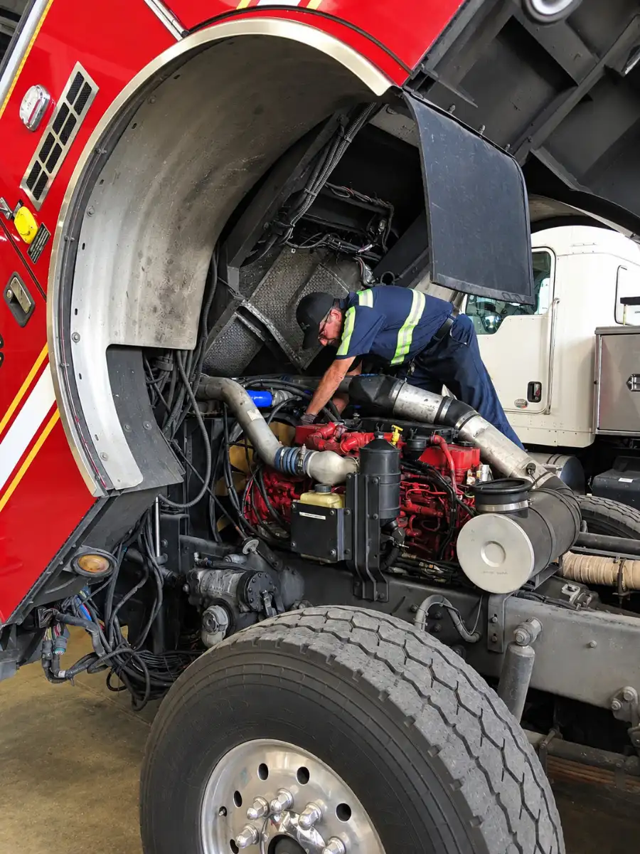 Fleet technician servicing the engine of a fire apparatus