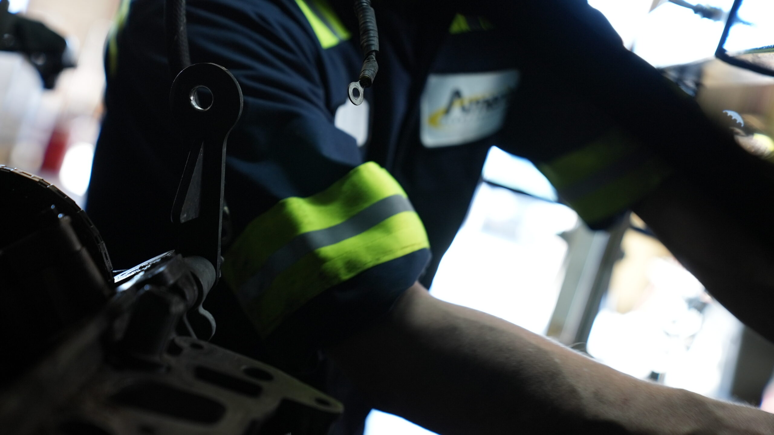 Amerit technician wears safety PPE and fixing vehicle.